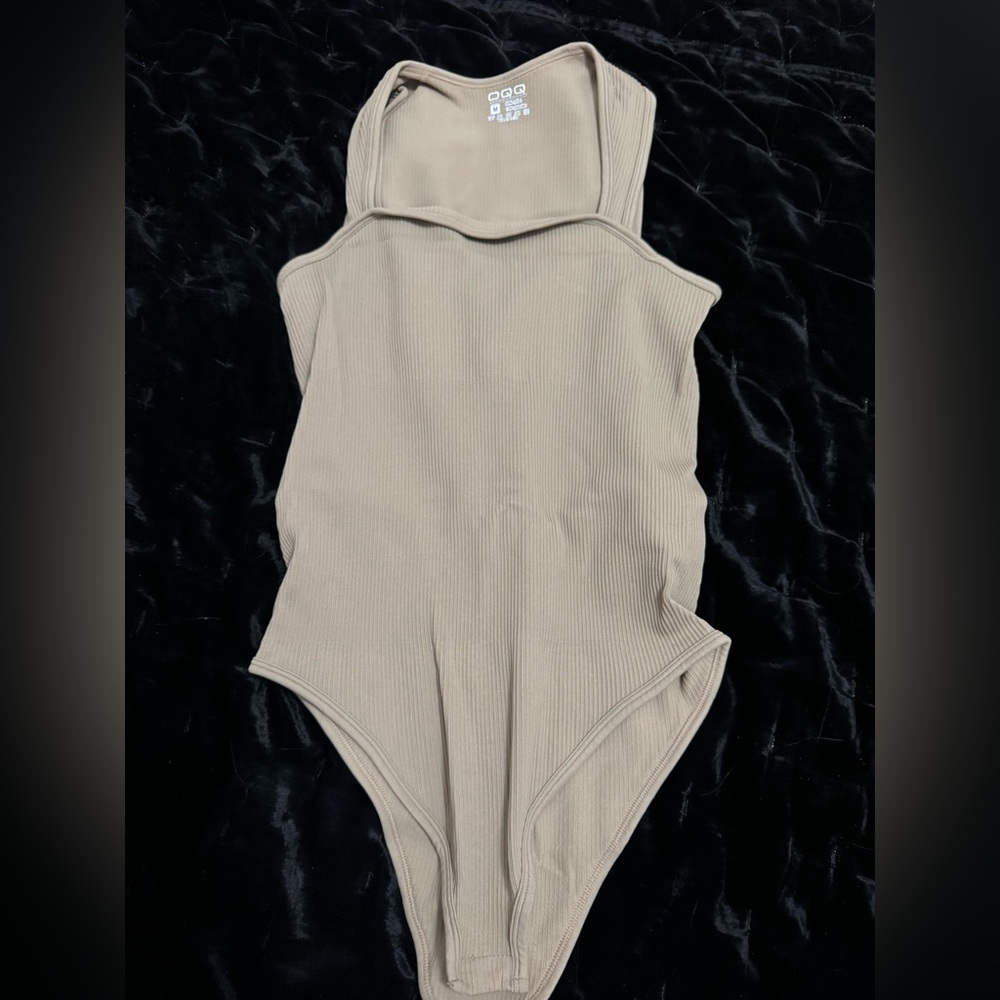 Tan Bodysuit with High-Cut Neckline and Sleek Design
